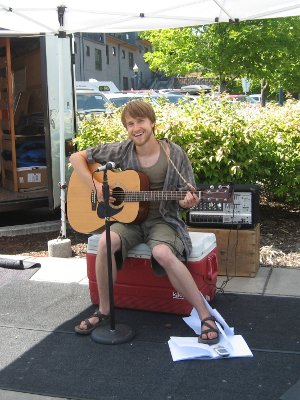 Sam, Intern 2010, playing his songs at a local farmer's market