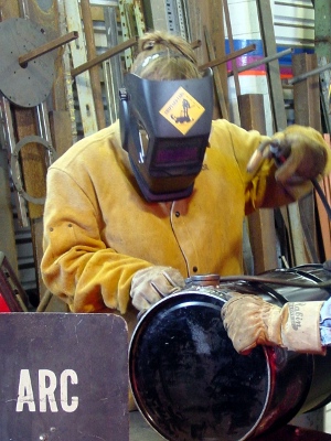 Opalyn building her welding skills working on thewood gasifier